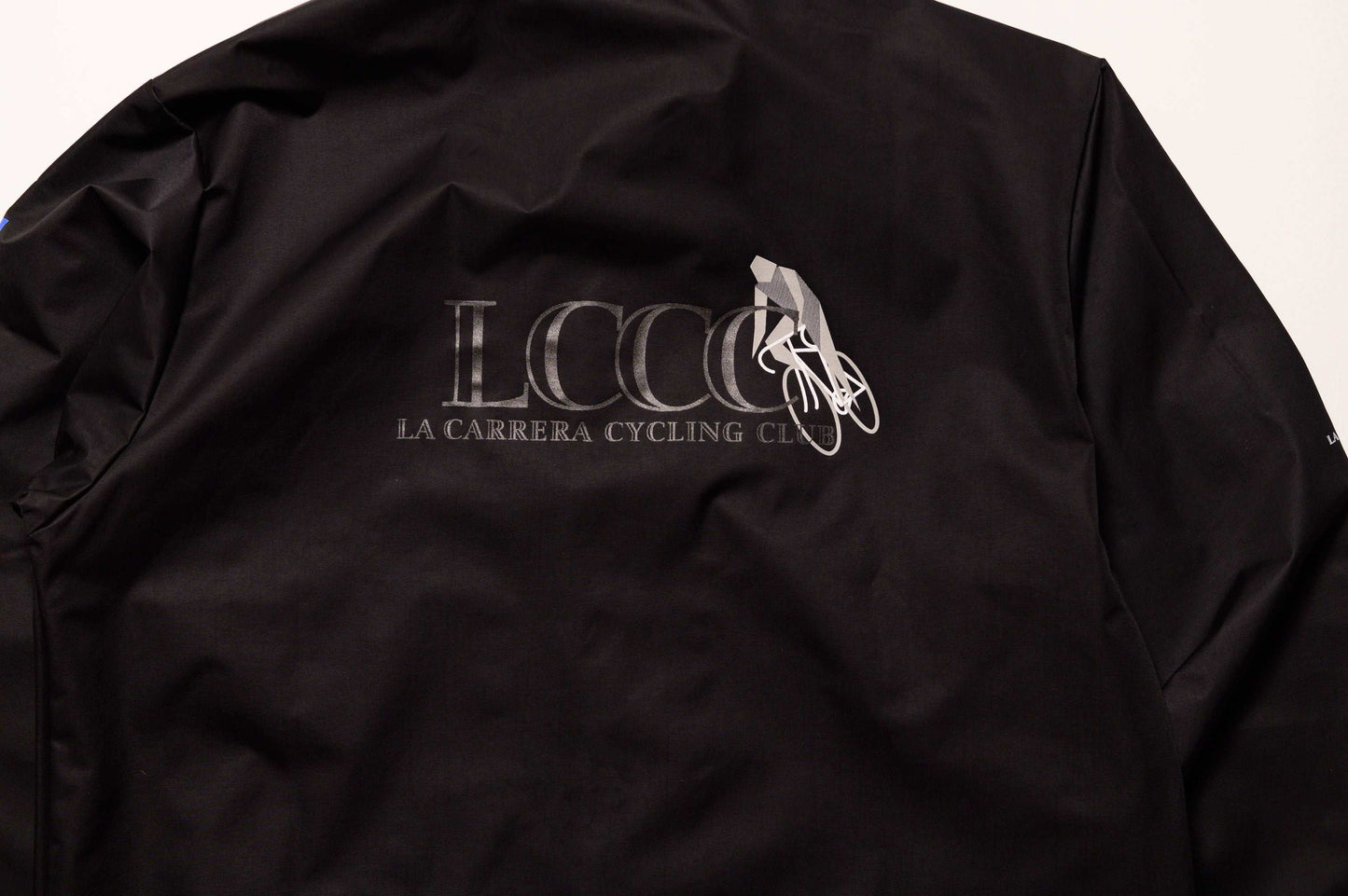 Close up of back view of LCCC Master Chrono reflective coaches jacket, highlighting reflective logo and clean design