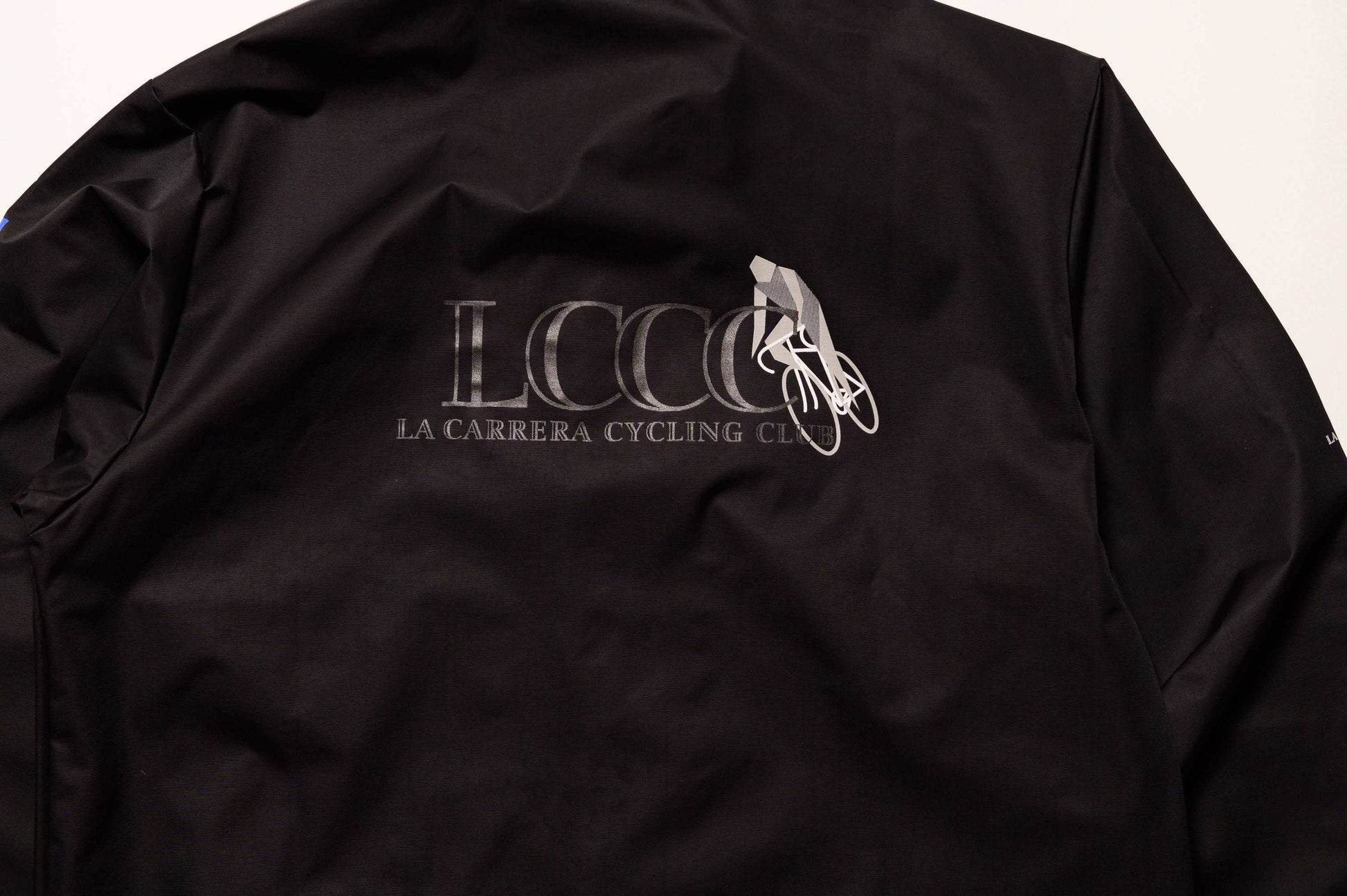 Close up of back view of LCCC Master Chrono reflective coaches jacket, highlighting reflective logo and clean design