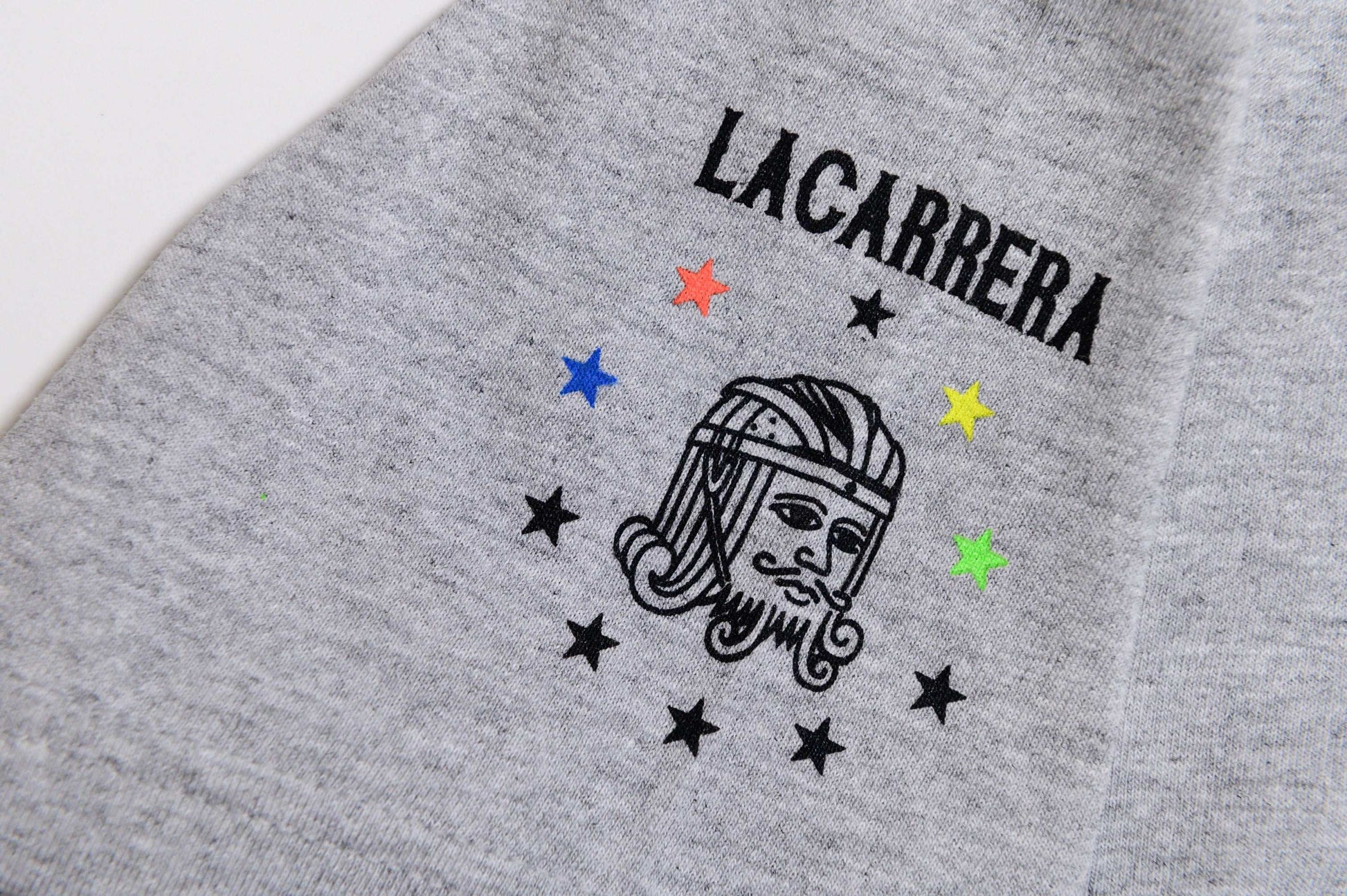Close-up sleeve hit view of Il Campionissimo tee by LCCC with focus on material and graphic