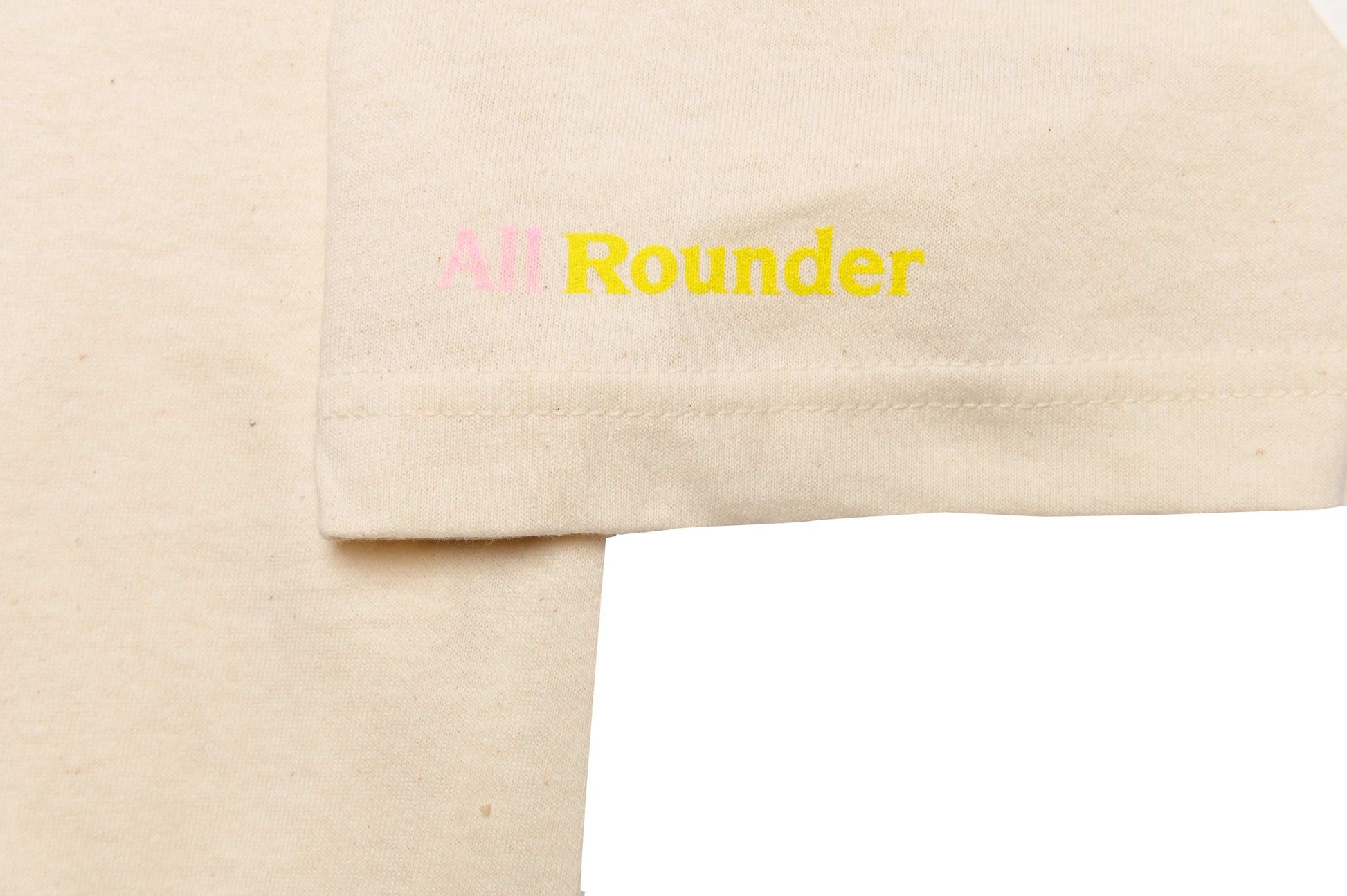 Close-up of Monsieur Chrono print sleeve detail on white/oatmeal tee by LCCC